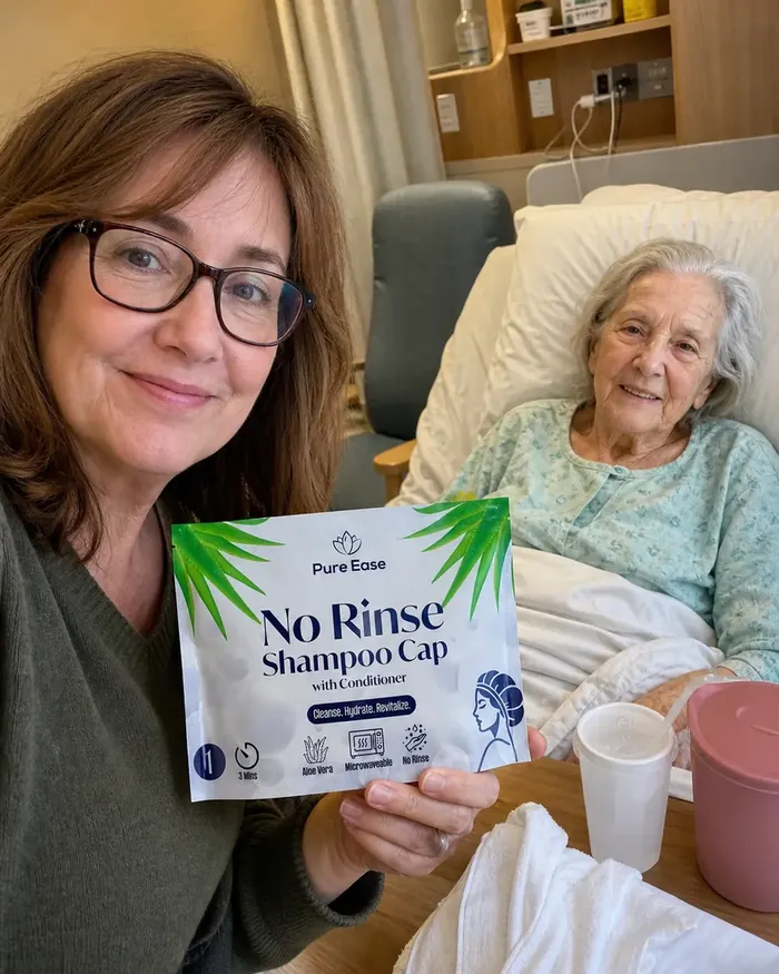 Daughter holding a PureEase no-rinse shampoo cap beside her elderly mother in a hospital bed