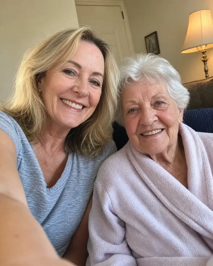Daughter and elderly mother smiling together on the sofa after using a PureEase shampoo cap