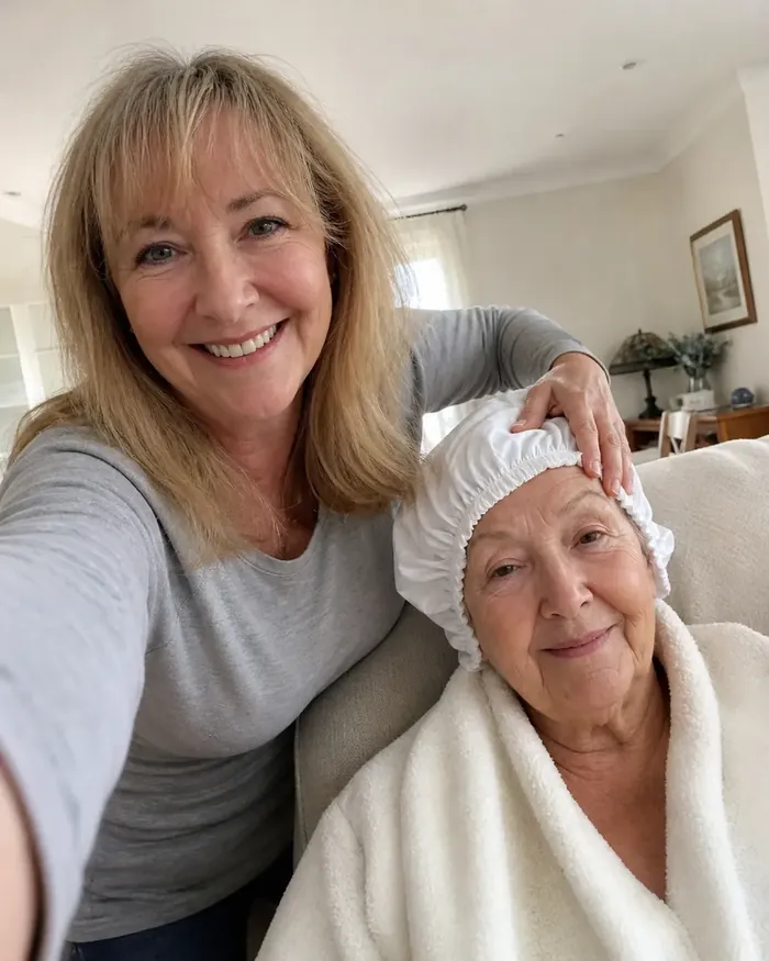 Carer with elderly mother wearing a PureEase no-rinse shampoo cap, wrapped in a towel